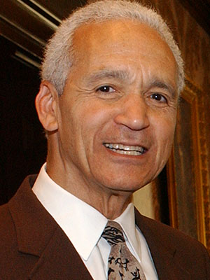 A smiling man in a suit and a tie.