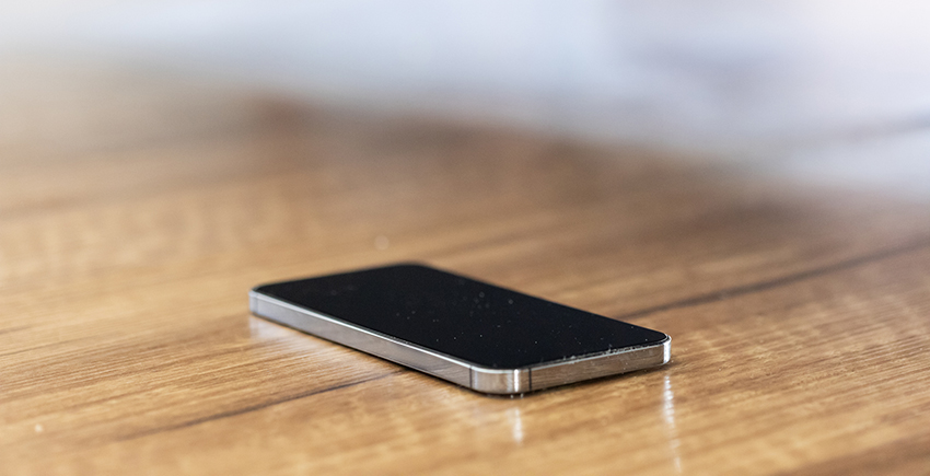 A phone with screen off sitting on a table