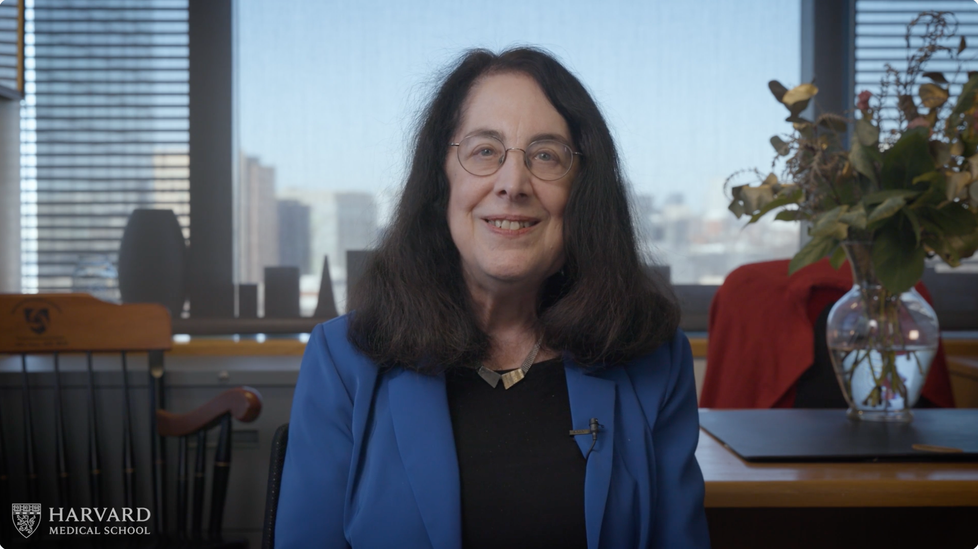 Arlene Sharpe smiles while looking at the camera in her office