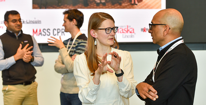 Two pairs of people talk to each other.