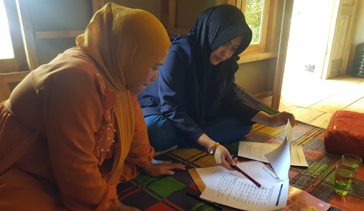 two people discussing a paper