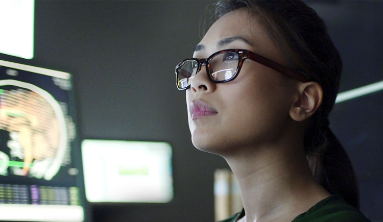 woman in glasses staring into the distance