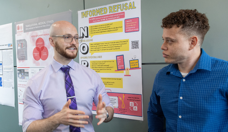 two people in front of a poster