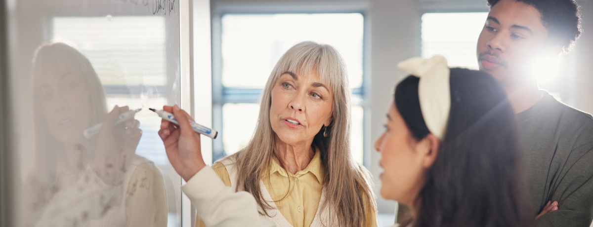 group of people working on whiteboard
