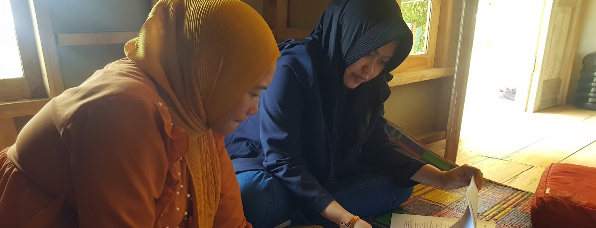 two people discussing a paper