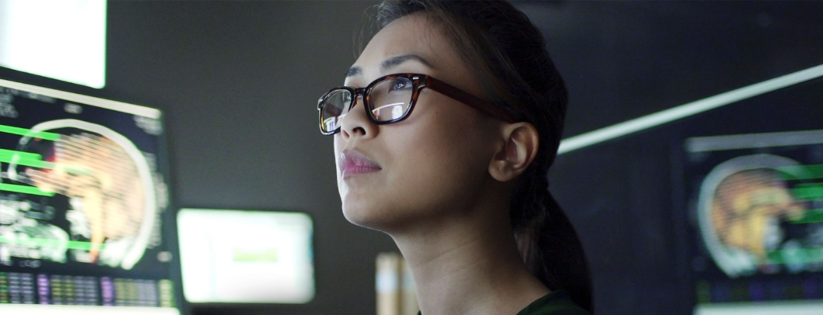 woman in glasses staring into the distance