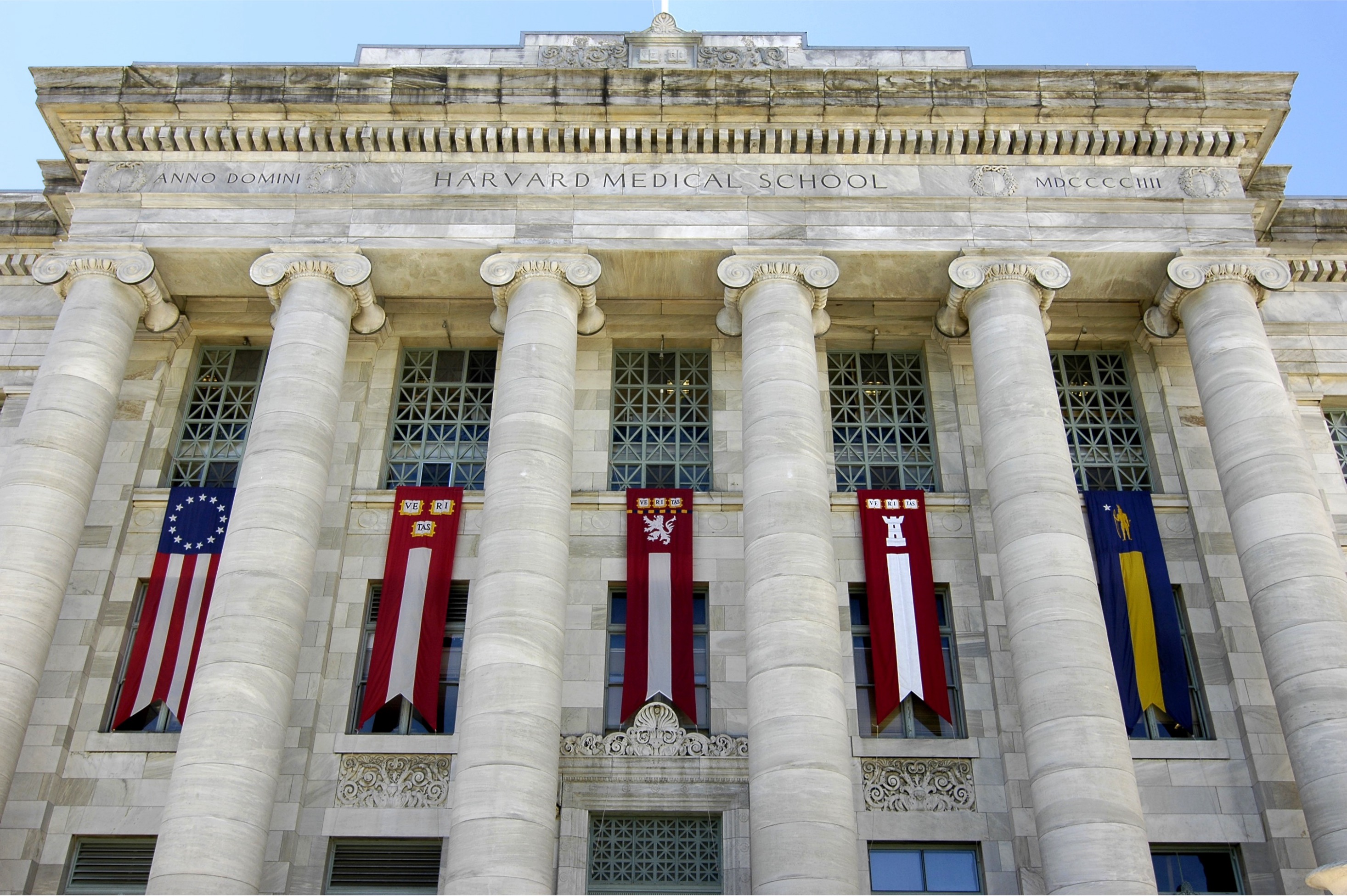 A view from looking up at the large marble pillars on Gordon Hall 