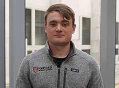 A man in a grey Harvard Medical School fleece jacket