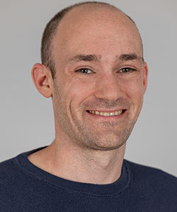 Photo of Alex Luedtke in front of a white background
