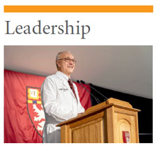 LEADERSHIP: Photo of Dean Daley wearing a white coat and speaking at a podium