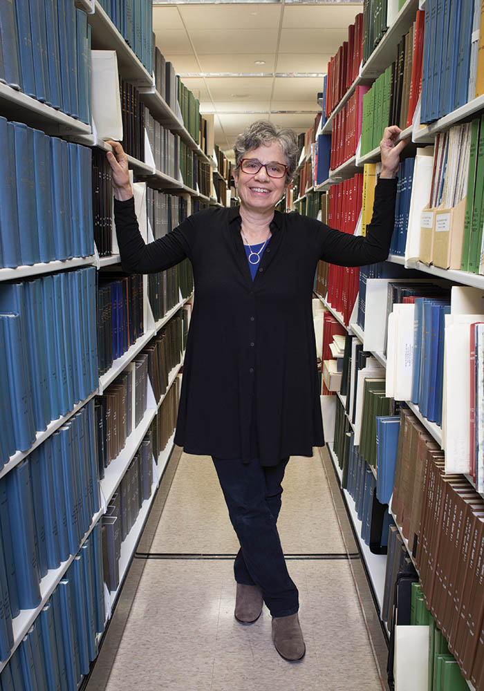 portrait of Deborah Zarin in books stacks at Countway Library