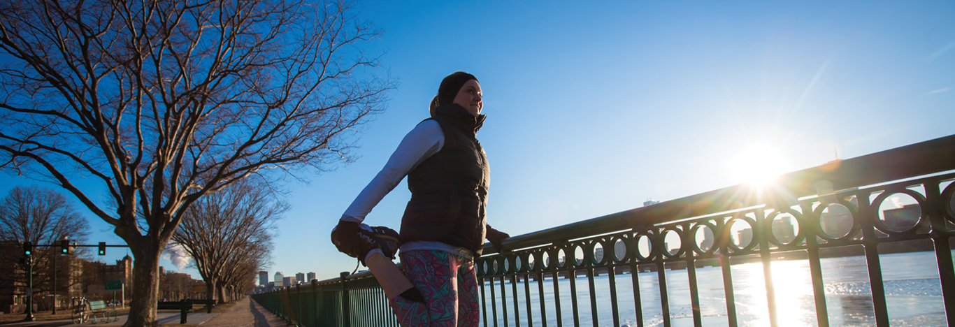 Chelsea Messinger stretching before a run along the Charle's River