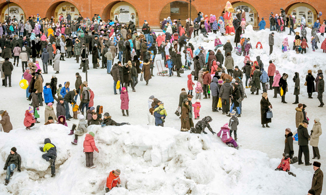 multitude of children and adults on snow-covered field