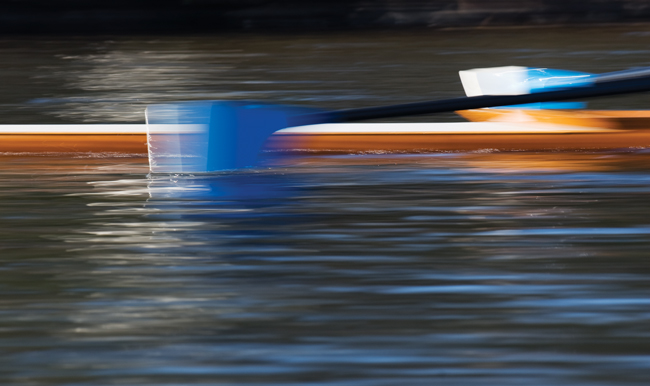 racing shell and oars on water