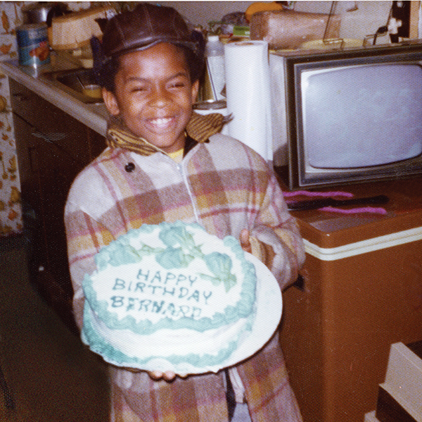 small boy holding large birthday cake, circa 1970