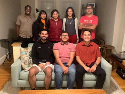 Students pose for a photo inside a house