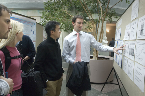 Lior Braunstein (in tie) explains his research on immune surveillance in the Soma Weiss Day poster session. Liza Green, HMS Media Services.