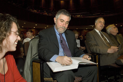 Helena Martins looks on as Nobel laureate Paul Krugman signs his autograph before delivering the 2009 Gay Lecture. Photo by Liza Green, HMS Media Services.