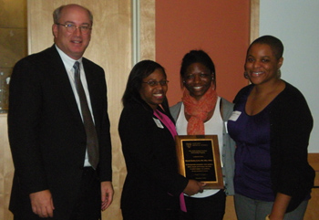 Rhonda Bentley-Lewis (holding plaque) accepts her mentoring award from (left to right) Peter Slavin and medical students Kristina Williams and Mekeme Utuk. Photo by Valerie Wencis.