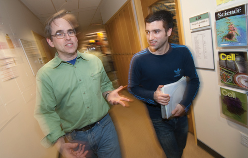 Peter Sorger (left) and Julio Saez-Rodriguez refined a literature derived signaling network using experimental data and created a mathematical model of that network’s behavior under different stimuli. The work revealed three signaling differences between cancerous and healthy liver cells—and potential therapeutic targets. Photo by Joshua Touster.
