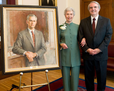 Top, Dean Jeffrey Flier presents a Revere bowl to Elizabeth Sweet, honoring her support of a new professorship in neuroscience. Above, she poses with first incumbent Robert Martuza, beside a portrait of her late husband, William. Photos by Suzanne Camarata.