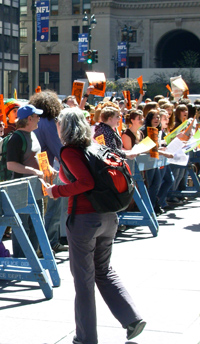 HMS staff member Anna Phelan leads a rally in New York City, part of the annual Get on the Bus event she helps organize with Amnesty International. Photo courtesy of Anna Phelan.