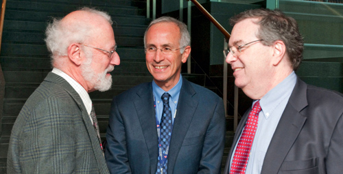 From left, pediatrician Gerald Hass, Russell Phillips, and Jeffrey Flier discuss issues in primary care at a recent town meeting on primary-care training. Photo by Paul Batista.