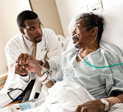 LeRoi Hicks (left), with a patient, first came to HMS in the Visiting Clerkship Program. Photo by Len Rubenstein Photography.