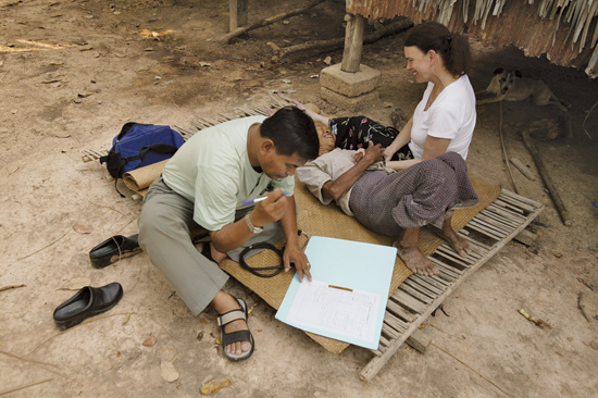 Anne Goldfeld (right) and Sok Thim (left) visit a TB patient at home in Cambodia. Photo by James Nachtwey.