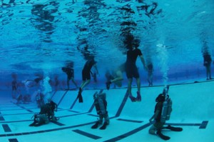 Under pressure: During Navy SEAL training in Coronado, Calif., students participate in a night gear exchange. Stress researcher George Everly has studied Navy SEALs and other resilient groups to identify distinct attributes of resiliency. Photo by Kyle D. Gahlau/U.S. Navy.