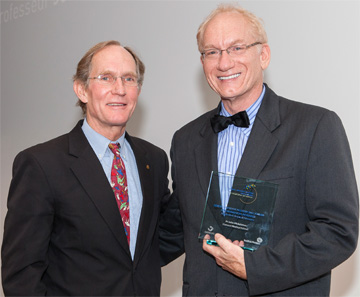 Juror Peter Courtland Agre (left) presents HMS Professor John Mekalanos with a 2012 Sanofi-Institut Pasteur Award. Photo by Franck Parisot