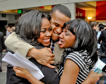 From left, Brittany Dixon, Cornell Cummings and Annika Barnett embrace after receiving their residency matches on March 15. Photo by Steve Lipofsky 