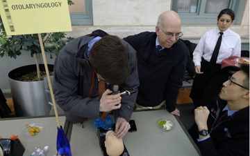 At the otolaryngology table at the HMS 2014 Residency Advisor Reception, students tried out a flexible fiber-optic scope on a pediatric mannequin head. Image: Jake Miller