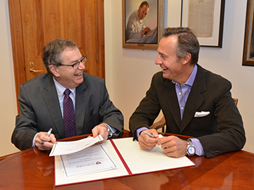 HMS Dean Jeffrey S. Flier signs the new agreement with Bertarelli Foundation co-president Ernesto Bertarelli. Image: Steve Gilbert