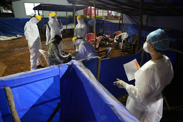 Nurse Kim Sprayer manages the triage area of the Maforki Ebola Treatment Unit during the night shift on January 9, 2015 in Port Loko, Sierra Leone.Image: Rebecca E. Rollins / Partners In Health