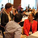 Elizabeth Armstrong (left) talks with Harvard Macy Institute course participants.