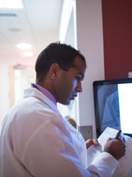 An HMS student prepares to examine a standardized patient in the Clinical Skills Center. Image: Gretchen Ertl for HMS