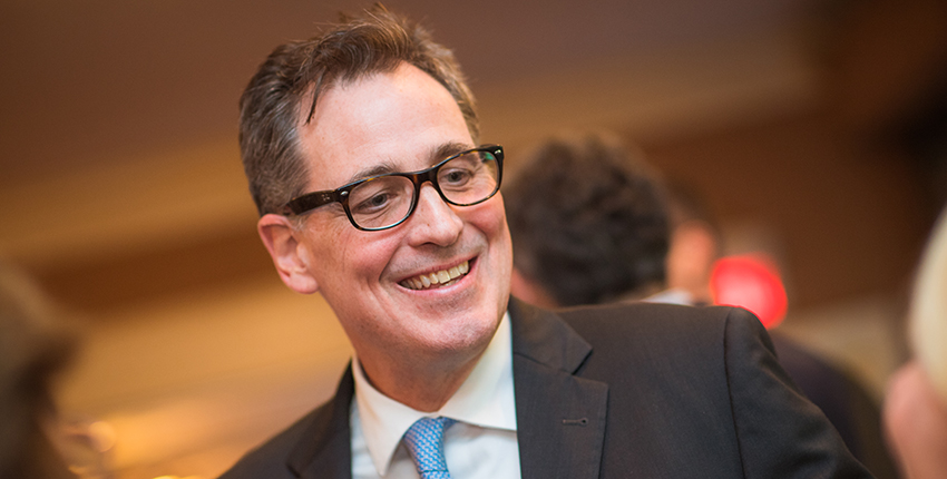 Head shot of a man in glasses and suit