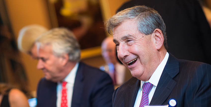 Head shot of gray-haired man smiling