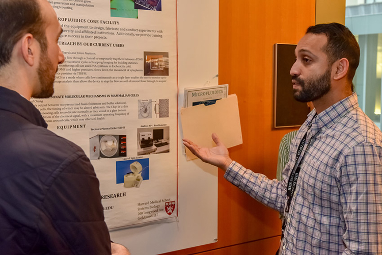 microfabrication-microfluidics poster presenter speaking to researcher 