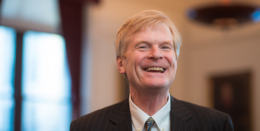 Red-haired man in suit and tie, smiling