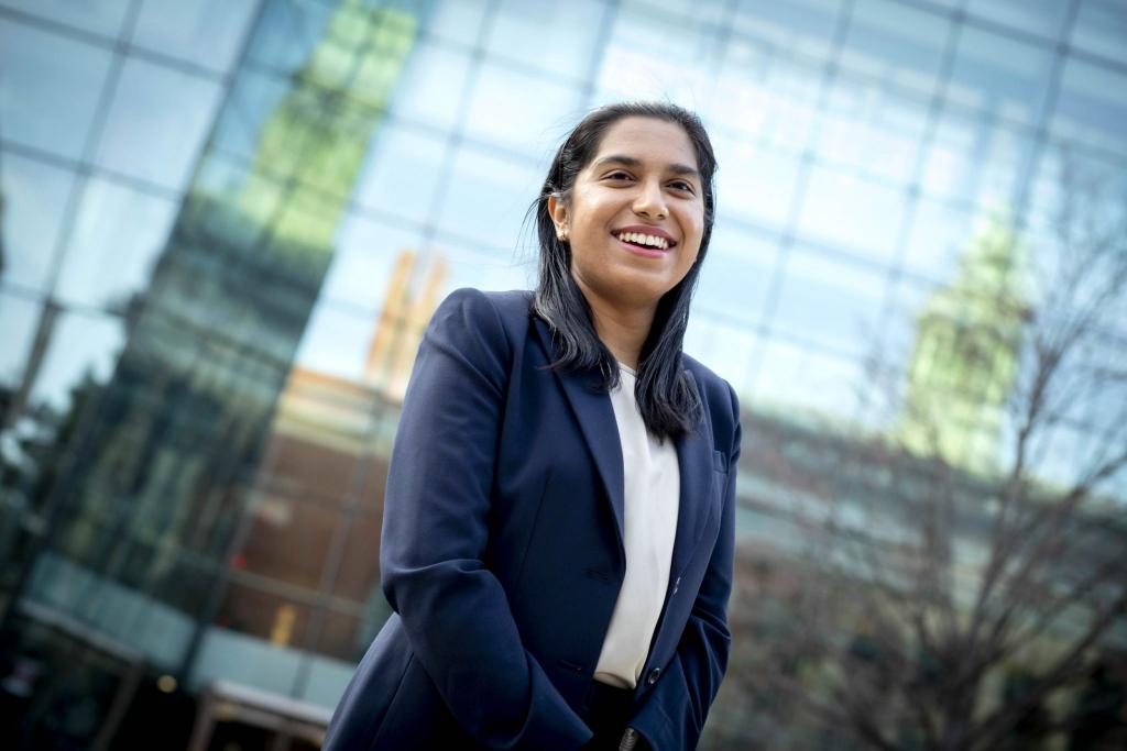 Photo portrait of Chandrashekar standing in front of glass building