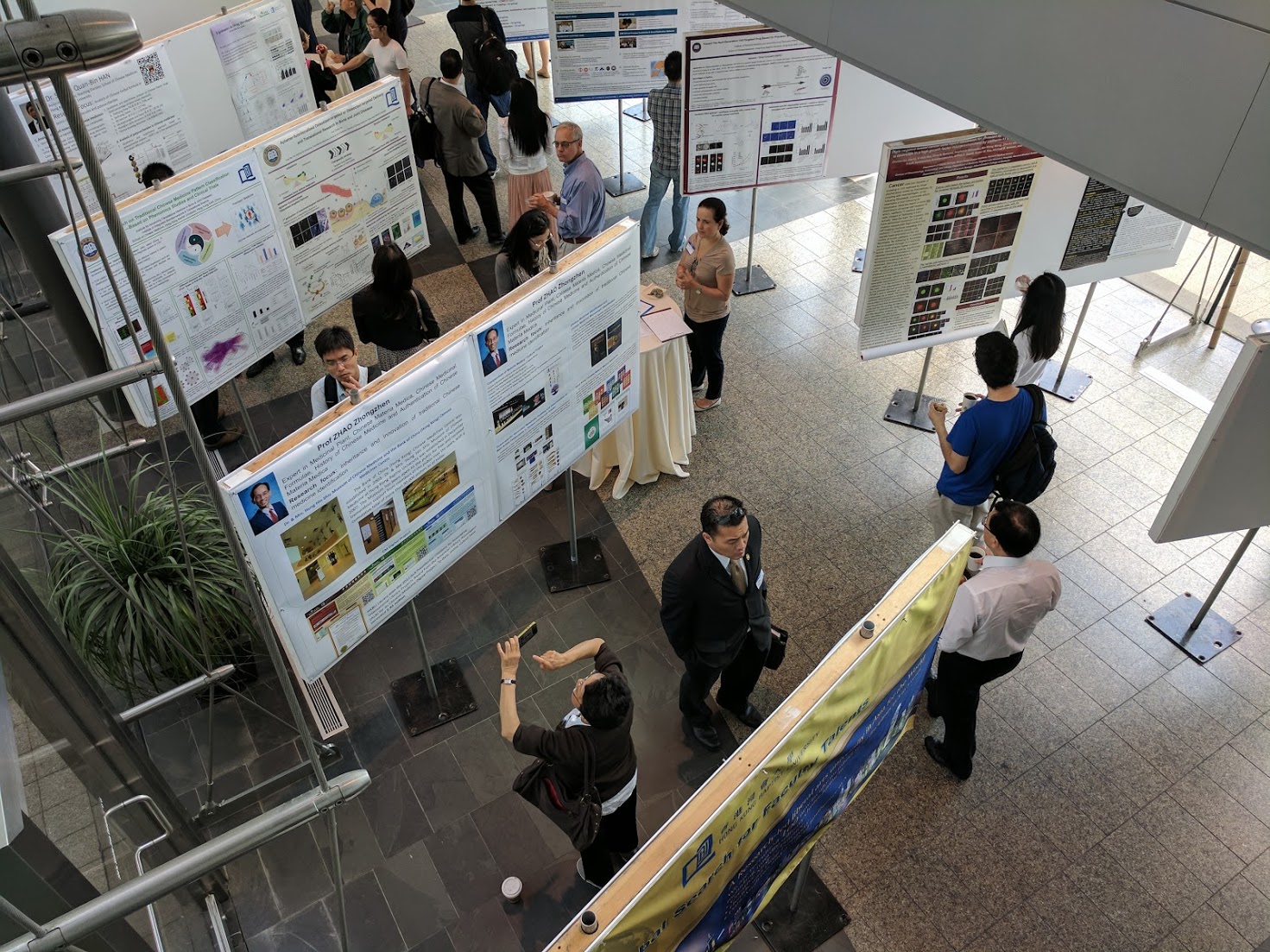 Attendees browse posters at the Traditional Chinese Medicine Symposium at HMS on June 20 and 21