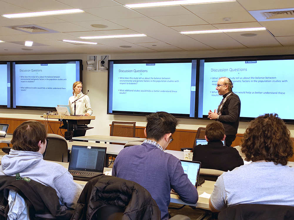 Zak Kohane (right) guides a student-led discussion