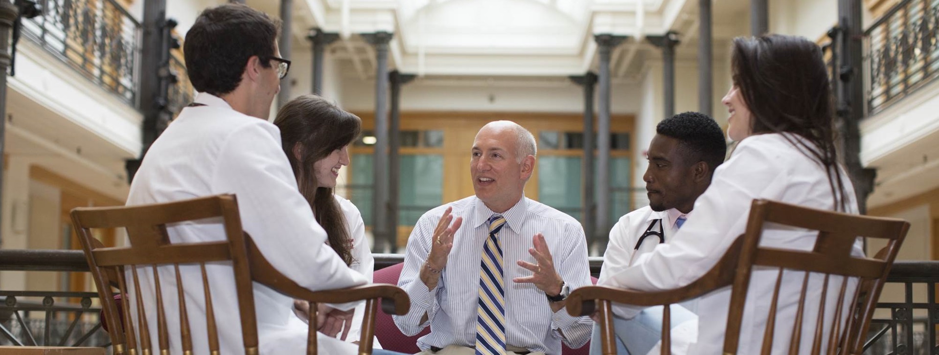 Man teaching group of doctors in white coats