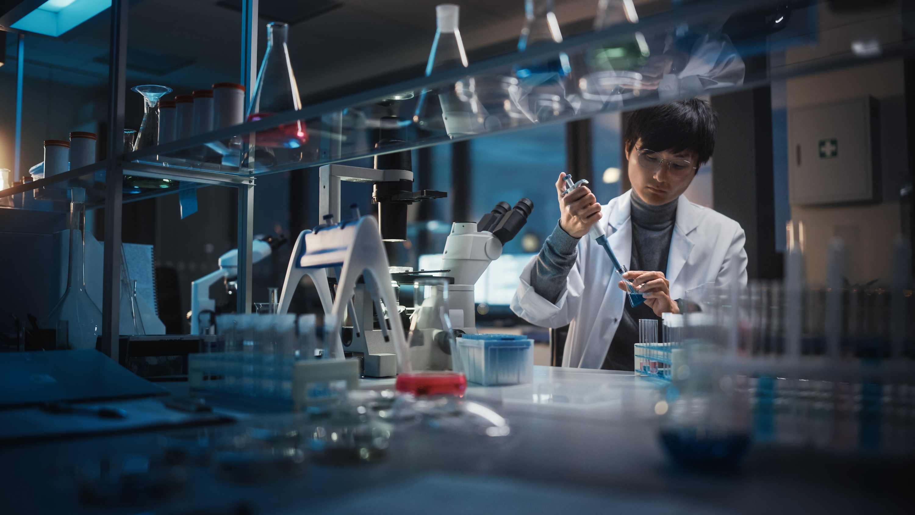 A lab worker using a dropper.