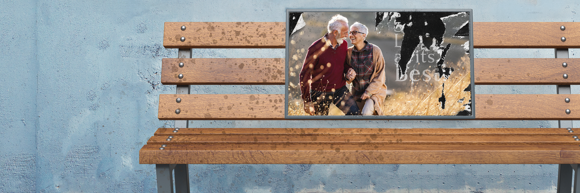 detail of image showing an empty park bench that has a weathered ad for assisted or independent living for older adults