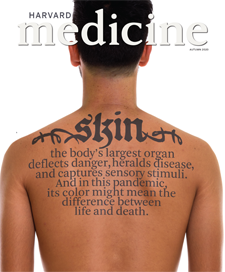cover of Autumn 2020 issue of Harvard Medicine magazine, upper torso of a male with "skin" tattooed across shoulders