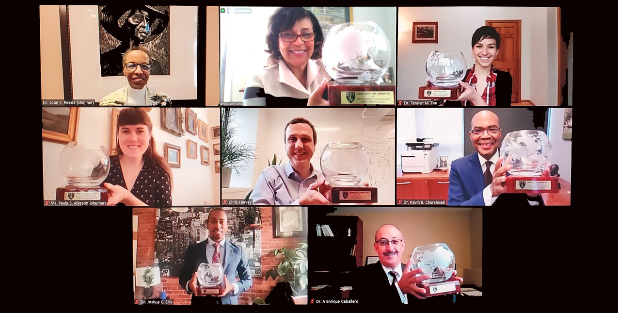 : Portraits of eight people smiling, with seven award winners holding commemorative crystal bowls. 
