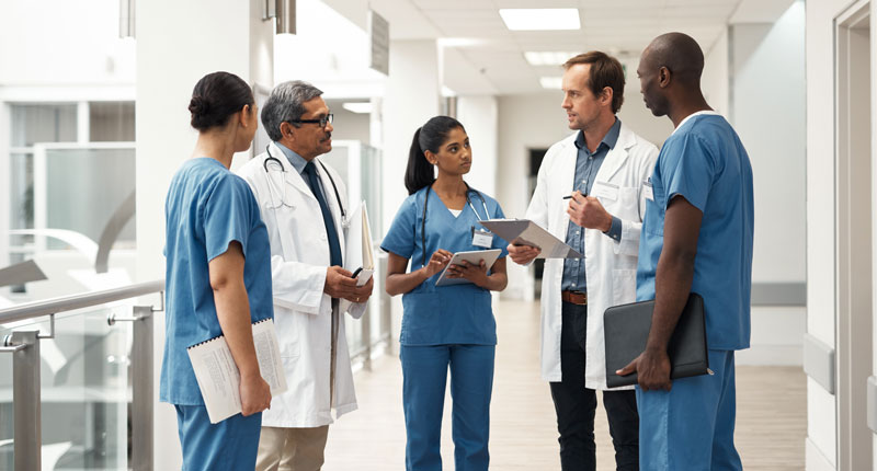 Doctors talking in a group in a hospital 